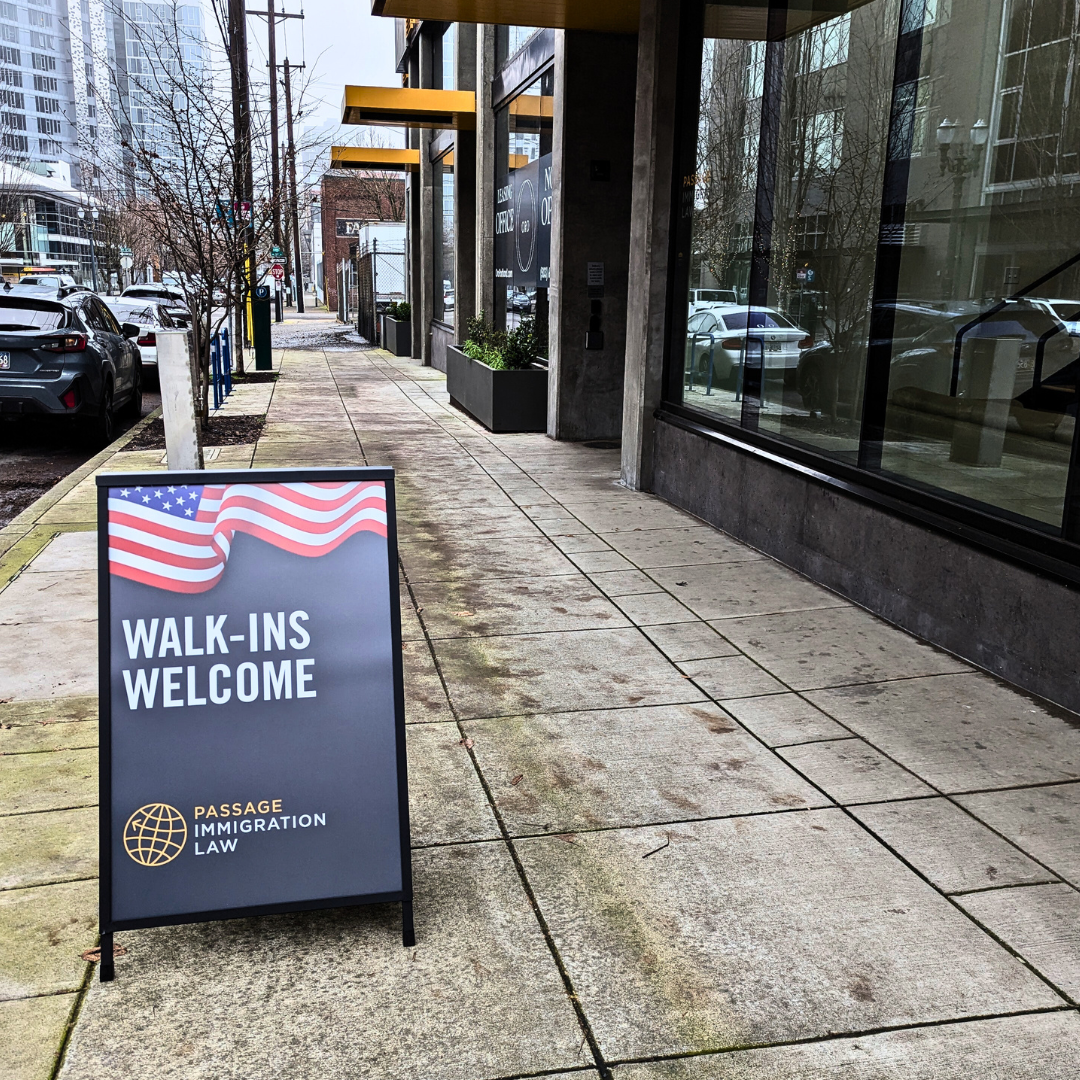 Sandwich board sign that says "Walk-Ins Welcome" right outside the entrance of Passage Immigration Law's new office in the Pearl. 